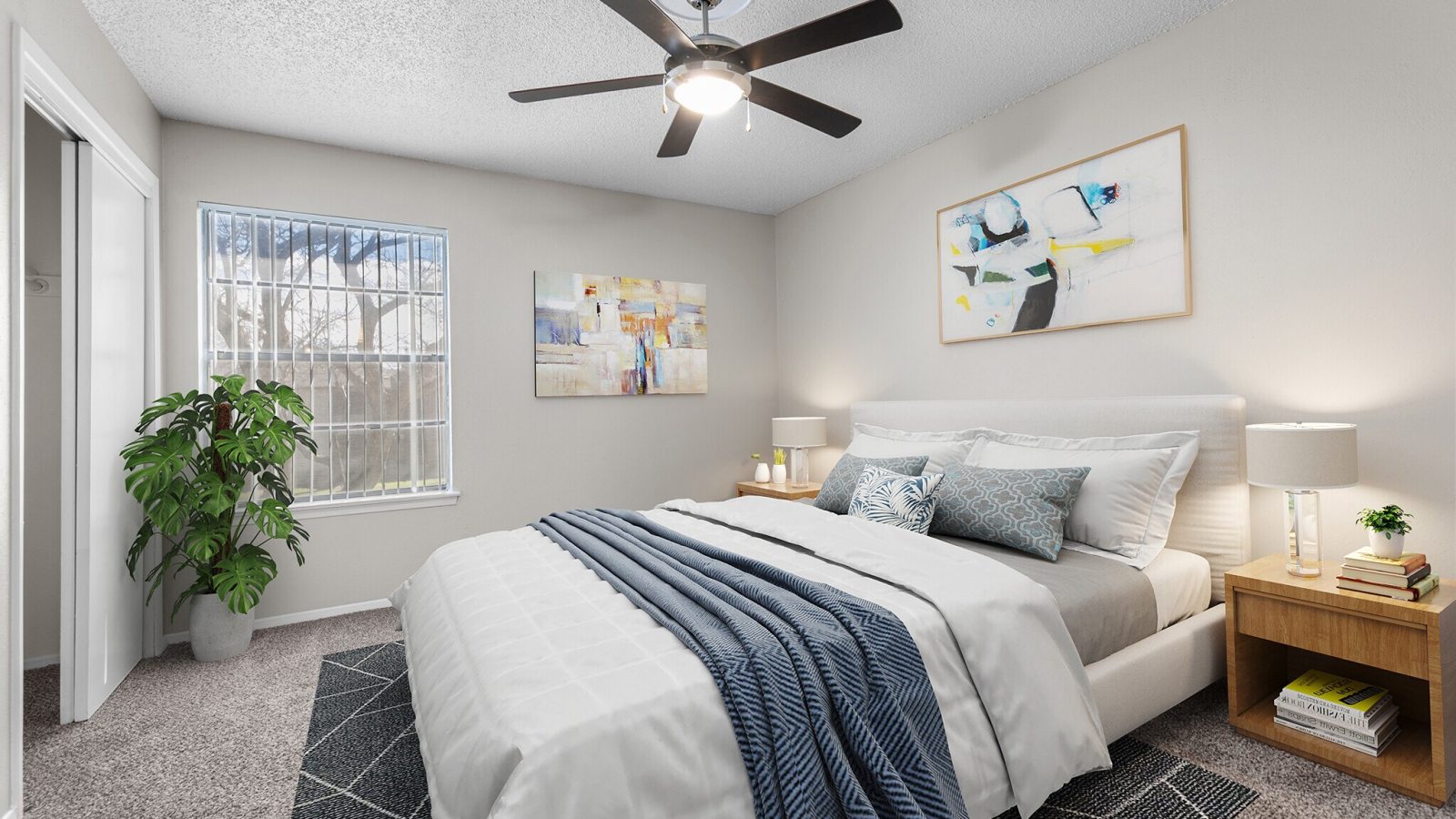 a bedroom with a ceiling fan and a bed at The Northwood Apartments
