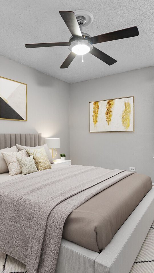 a bedroom with a ceiling fan and a bed at The Northwood Apartments