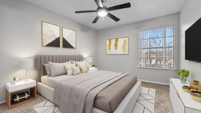 a bedroom with a ceiling fan and a bed at The Northwood Apartments